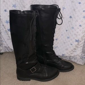 Lace up black boots.